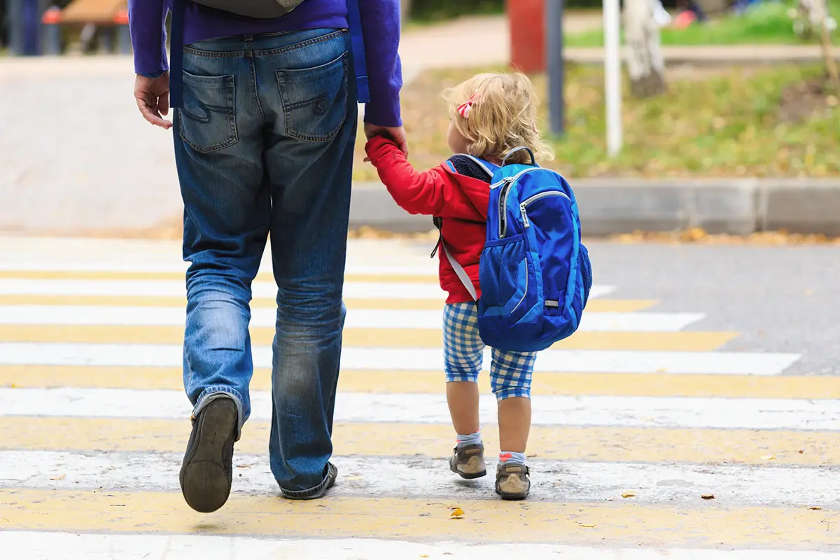 Photo of a parent walking kid to school