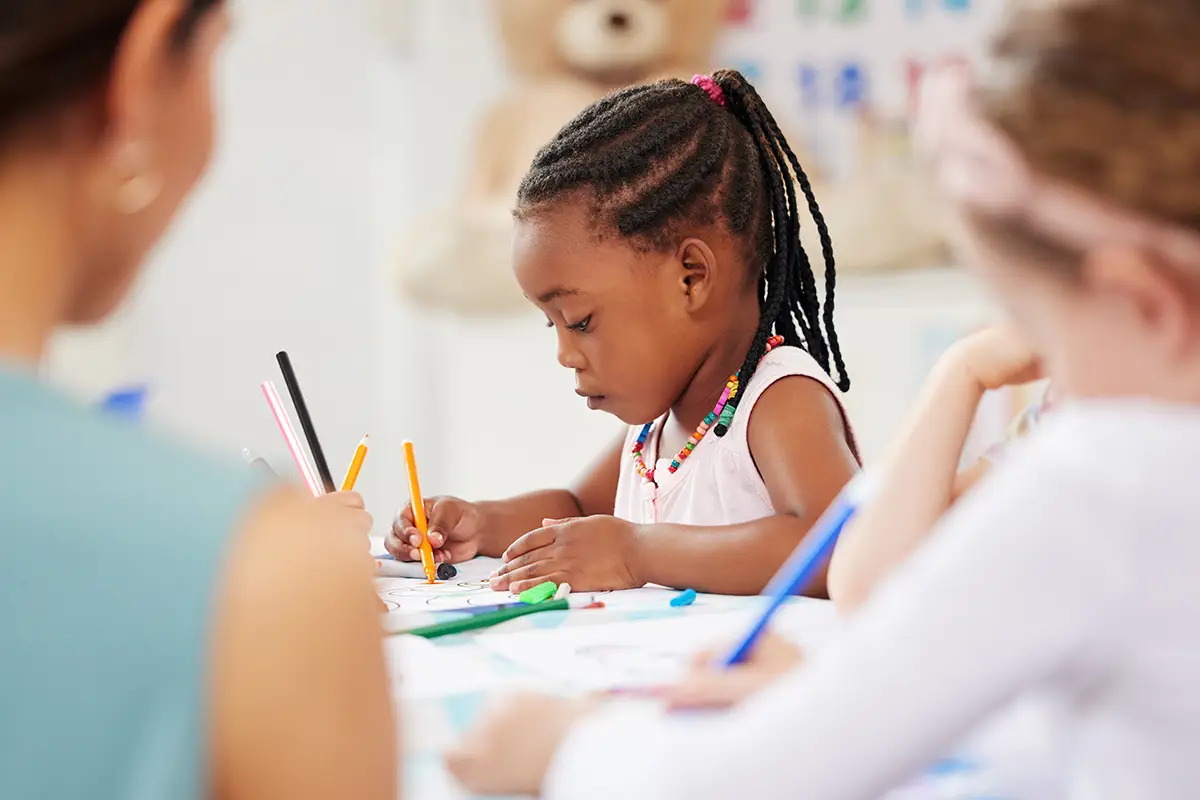 Photo of a little girl holding a pencil