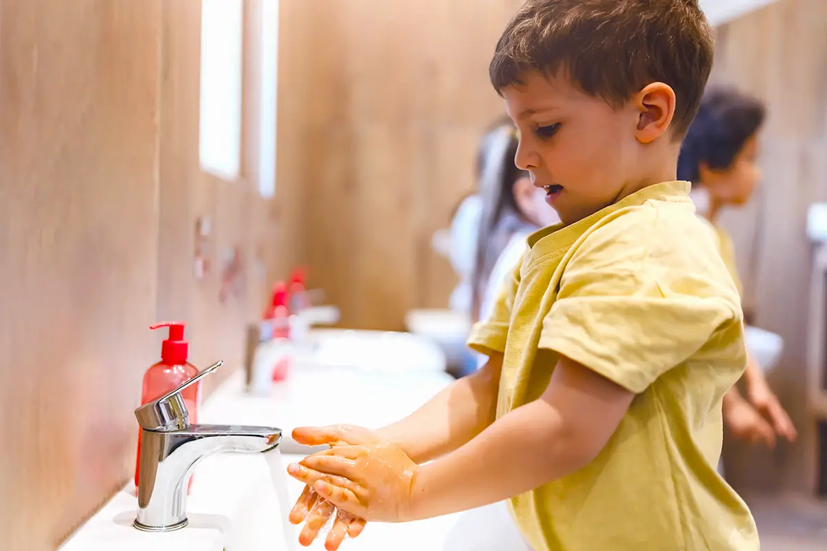 Photo of kid washing hands